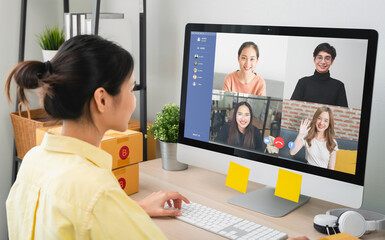 Young woman using computer on table with making video call meeting to team online and present work...