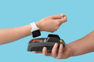 Buyer paying for purchase via terminal on color background