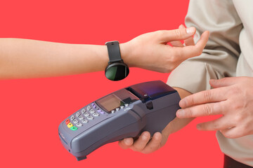 Buyer paying for purchase via terminal on color background