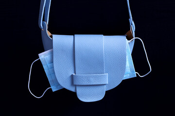 ladies blue fashion bag with medical mask inside, walk during pandemic, leather texture of...