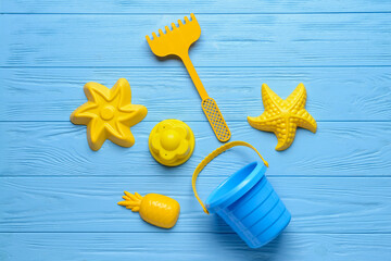 Set of beach toys for children on color wooden background