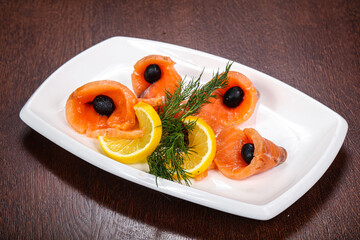 Sliced salmon snack with lemon