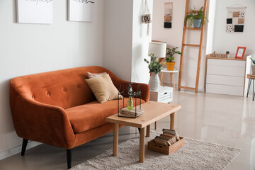 Stylish interior of living room with comfortable sofa