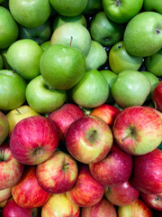 Fresh green and red apples on shelf. View from above