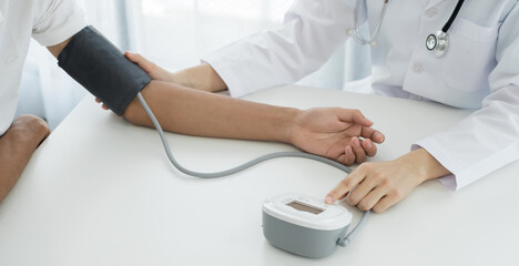 Female doctors measured blood pressure, the patient examined the heartbeat and talked about health care closely. Medical and health care concepts