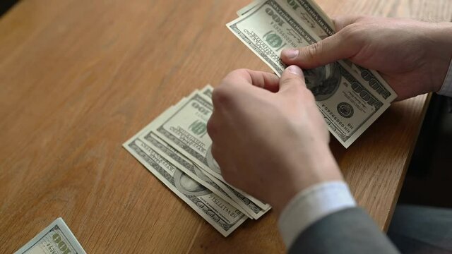 Close up male hand Counting money us dollar. Financial business concept.