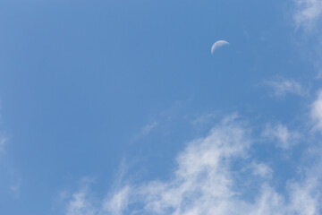 The white crescent moon in the afternoon cool white clouds on beautiful afternoon sky background Images for clear sky background design make you feel fresh and airy.
