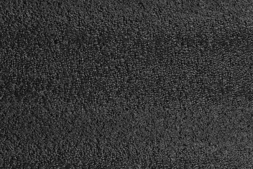 Black foam plastic background texture. black background for designers. dark styrofoam