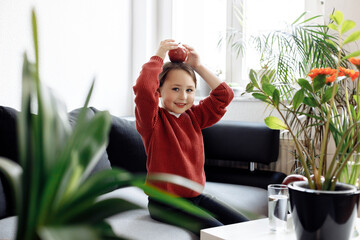 Child holding apple on head, healthy lifestyle concept