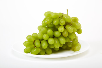 ripe green grapes on a white plate