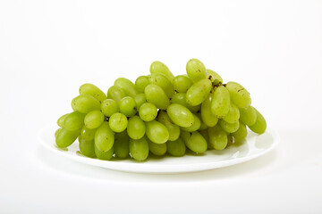 ripe green grapes on a white plate