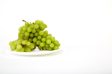 ripe green grapes on a white plate
