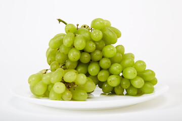 ripe green grapes on a white plate
