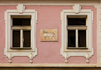 Windows and medieval wall stone with lamb in Prague (Czech Republic)