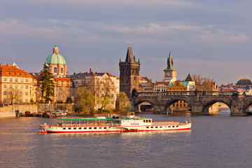 Obraz na płótnie Canvas River boat on Moldau in Prague near Charles Bridge