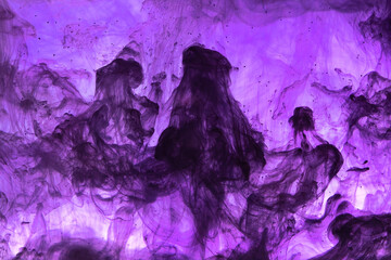 Abstract background picture with purple paint dissolving in water	