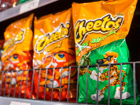 Manila, Philippines - Sept 2020: Cheetos is a brand of snacks made by Frito-Lay. Original and Cheesy Jalapeno flavors on an aisle at a supermarket.