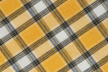 Yellow white tartan texture background. shirt fabric with a checkered pattern. factory material
