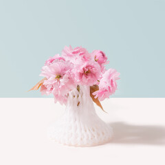 Magical  Japanese cherry flowers in 3D printed net still life concept. Ultimate gray and  light beige background.