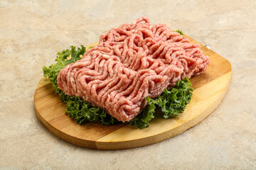 Raw pork minced meat over board