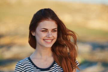 Fototapeta premium happy woman in the mountains outdoors smile laughter makeup model