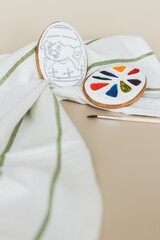 Glazed biscuits in the shape of an Easter egg with the ability to color them with food colors palette. Gingerbread with a picture of a chicken that hatched from an egg