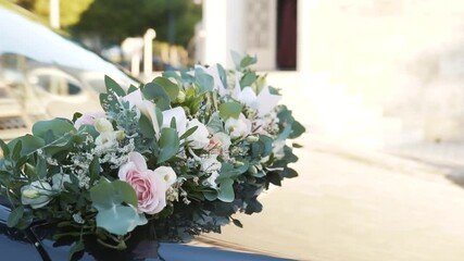 Wedding floral decoration on the car. Composition of pink and white roses with green leaves