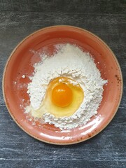 Still life with flour, egg on the kitchen table