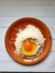 Still life with flour, egg on the kitchen table