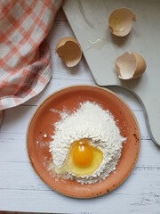 Still life with flour, egg on the kitchen table