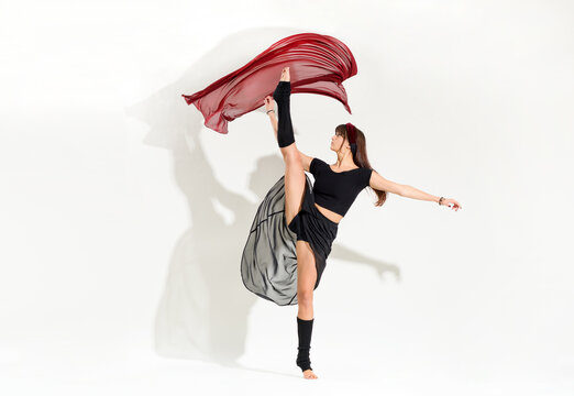 Agile young dancer performing a dynamic developpe ice skating pose