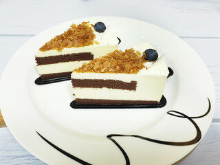 Two pieces of chocolate cake on a white plate, birthday party