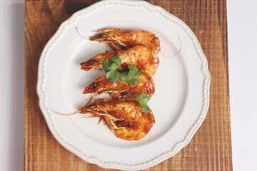 Fried shrimp with sauce on a white dish, delicious food, top view