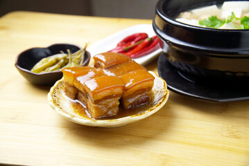 Braised pork and Tofu soup, green and red peppers, traditional Chinese cuisine, blurred background