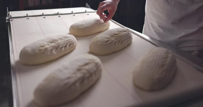Baker Making Patterns On Raw Bread Using A Knife, slow motion 4k video 