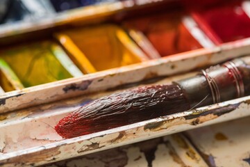 Set of watercolor paints and paintbrushes for painting closeup.