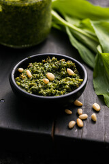 Fresh homemade wild garlic pesto. Home made sauce made with wild garlic, pine nuts, cheese and olive oil.