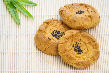 A few walnut cookies on sushi mat, black sesame, delicious dessert, top view, copy space