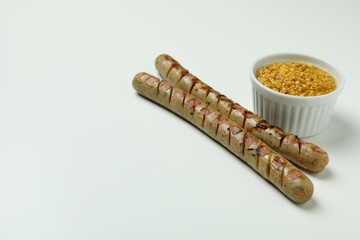 Grilled sausage and sauce on white background