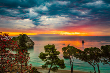 Beautiful morning on the beach after a tropical storm, dramatic sky, tropical trees in Mazzaro, Taormina, Sicily