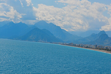 blue sky with clouds with mountains with sea 