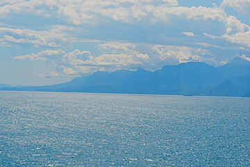 blue sky with clouds with mountains with sea 