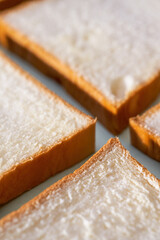 The slices of toast bread filling the picture are spread out on the table