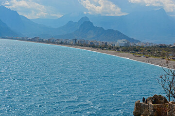 long beach with mountains and blue sea with sunny day