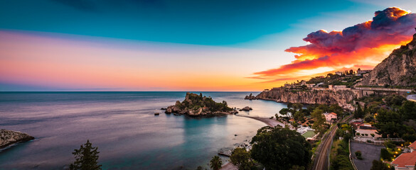 Panoramic view of Isola Bella in Taormina, Sicily  by the warm sunset light 