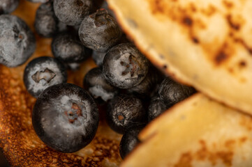 Fresh blueberries and traditional Russian pancakes. Shrovetide week of the end of winter.