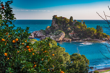 Orange trees and turquoise sea at Isola Bella in Taormina, Sicily 