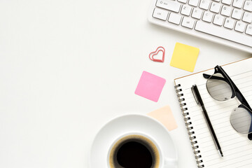 Top view office table, Side space for creative business idea with book, silver pen, glasses, black coffee, notepads and keyboard is elements.