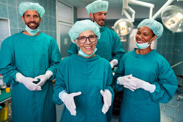 Portrait of a successful medical surgeon team inside operating room