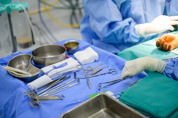Orthopedic doctor and assistant team are preparing tools for arm bone surgery in hospital operating room.